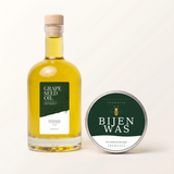 TheWootz onderhoudsset 500 ml: glazen fles druivenpitolie met kurk naast blik bijenwas 50 g