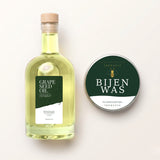 Fles druivenpitolie en blikje bijenwas van TheWootz voor houten snijplanken, van bovenaf gefotografeerd.